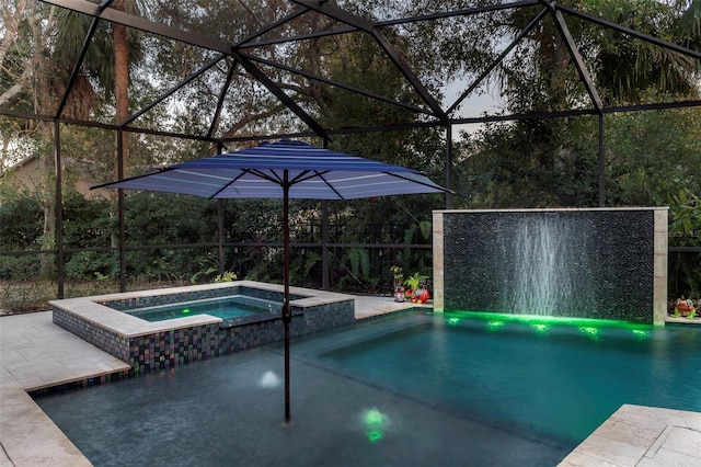 view of pool featuring a lanai, a patio, and an in ground hot tub