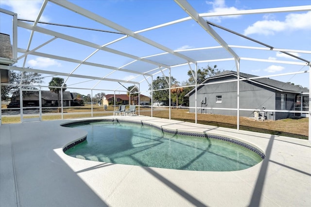 view of pool with a patio and glass enclosure