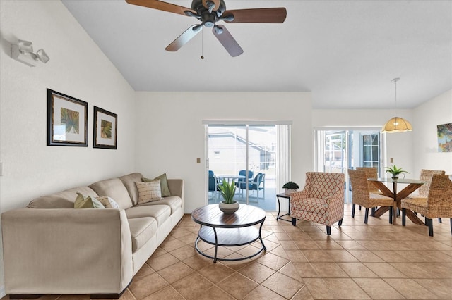 living room with lofted ceiling, light tile patterned floors, and ceiling fan