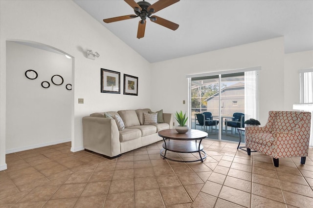 living room featuring light tile patterned floors, high vaulted ceiling, and ceiling fan