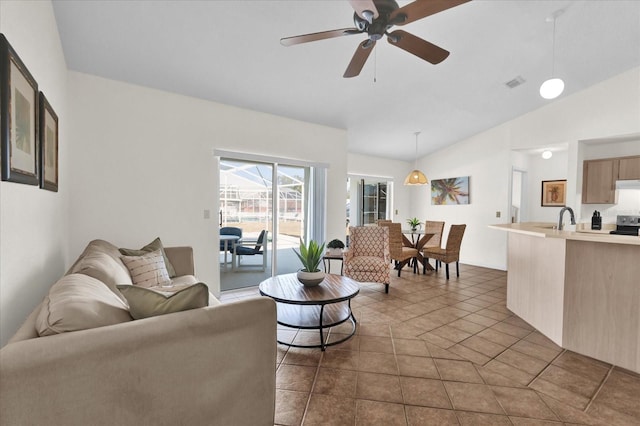 tiled living room with vaulted ceiling, ceiling fan, and sink