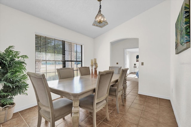 tiled dining area featuring lofted ceiling