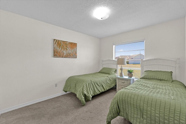 bedroom featuring light colored carpet and a textured ceiling