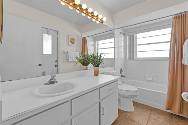 full bathroom featuring toilet, a healthy amount of sunlight, tile patterned floors, and shower / tub combo with curtain