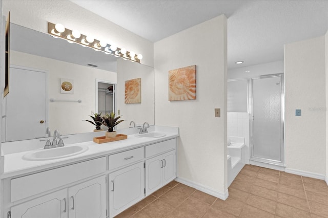 bathroom featuring independent shower and bath, vanity, and tile patterned floors