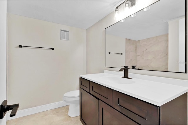 bathroom featuring vanity, tile patterned flooring, and toilet