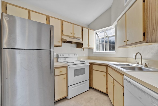 kitchen with vaulted ceiling, cream cabinets, sink, and white appliances