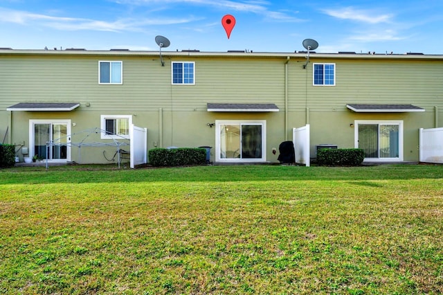 rear view of house with a yard