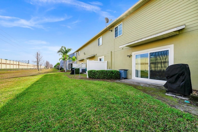 exterior space featuring central AC and a lawn