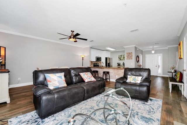 living room with ceiling fan, ornamental molding, dark hardwood / wood-style floors, and sink