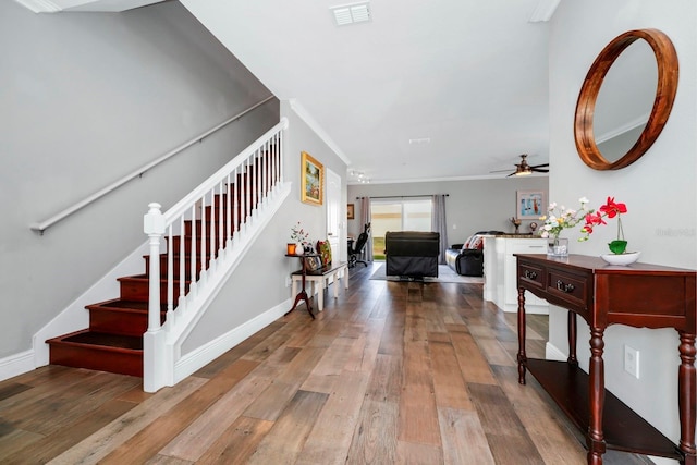 entrance foyer with hardwood / wood-style flooring, ornamental molding, and ceiling fan