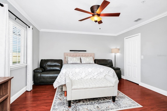 bedroom with crown molding, ceiling fan, and dark hardwood / wood-style flooring