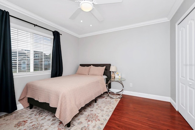 bedroom with wood-type flooring, ornamental molding, and ceiling fan