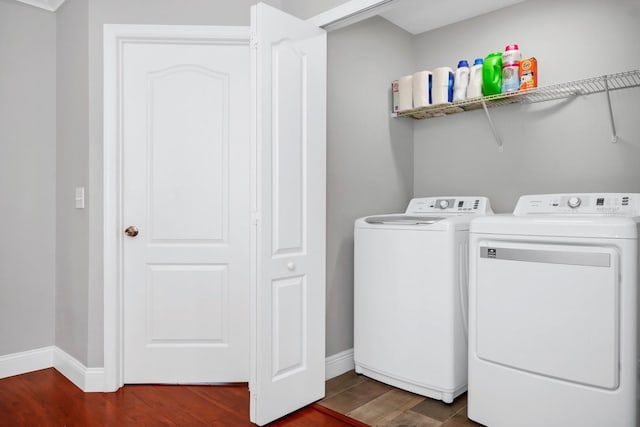 laundry room featuring dark hardwood / wood-style flooring and washer and clothes dryer