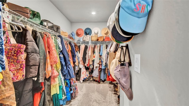 walk in closet featuring carpet flooring