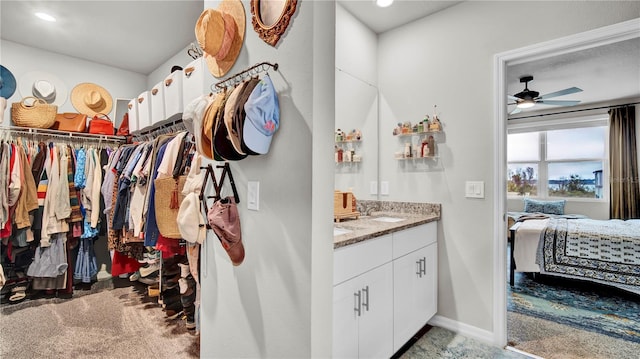 bathroom featuring ceiling fan and vanity