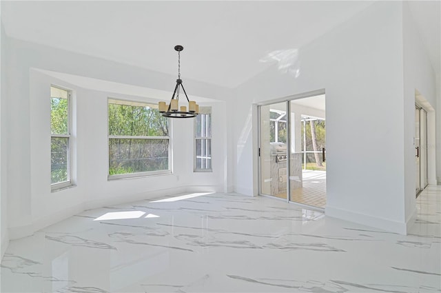 dining room featuring a chandelier, vaulted ceiling, and a wealth of natural light