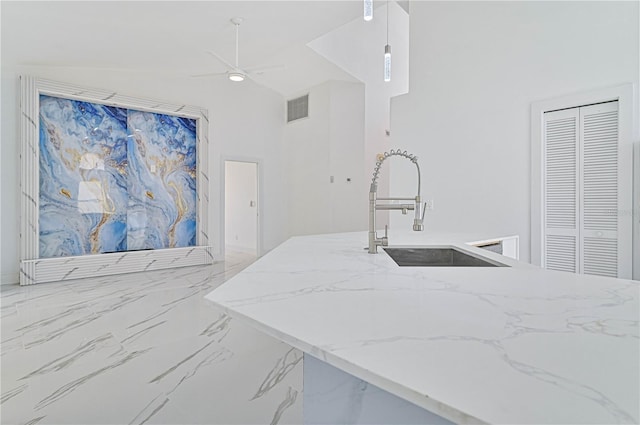 kitchen featuring sink and a high ceiling