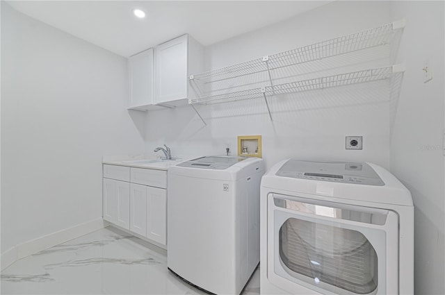 laundry room with sink, cabinets, and washing machine and clothes dryer