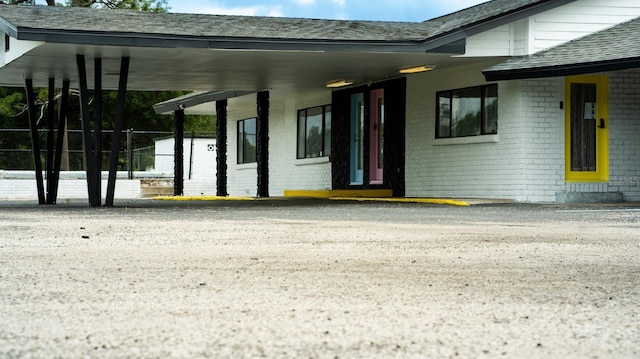 property entrance featuring a carport