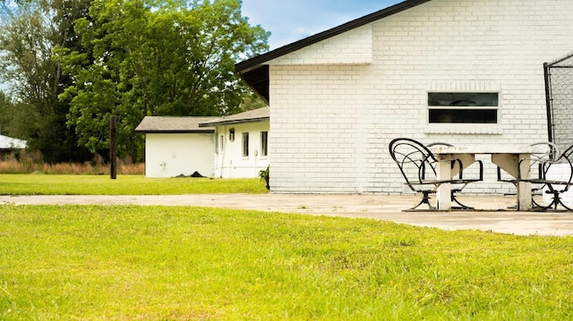 rear view of property with a yard and a patio area