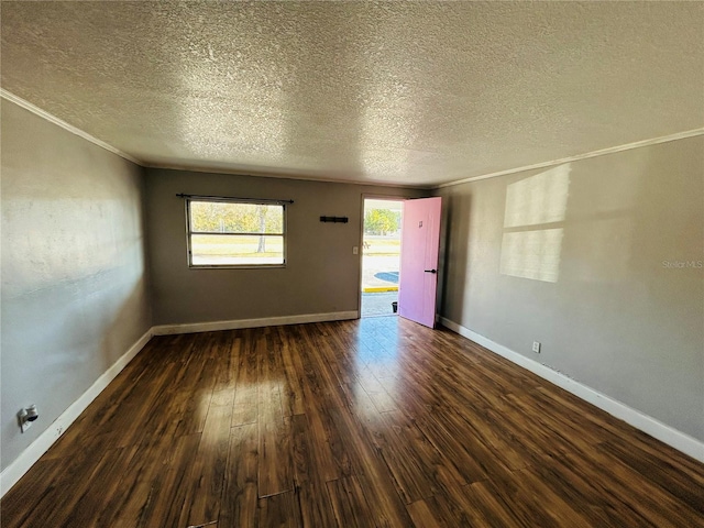 empty room with crown molding, dark wood-type flooring, and a textured ceiling