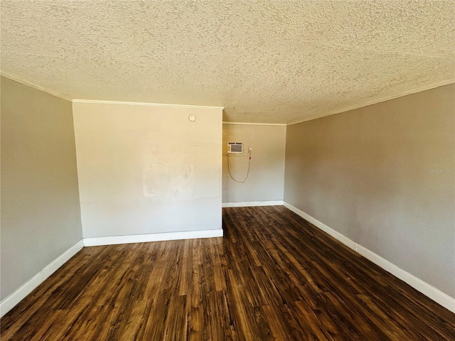 unfurnished room featuring crown molding, a textured ceiling, dark hardwood / wood-style floors, and a wall mounted AC