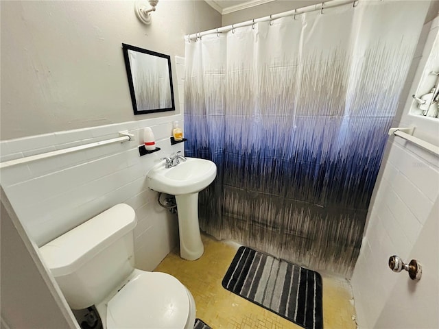 bathroom featuring curtained shower, tile walls, and toilet