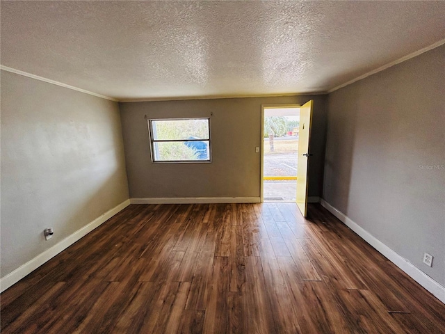 spare room featuring crown molding, plenty of natural light, dark hardwood / wood-style floors, and a textured ceiling