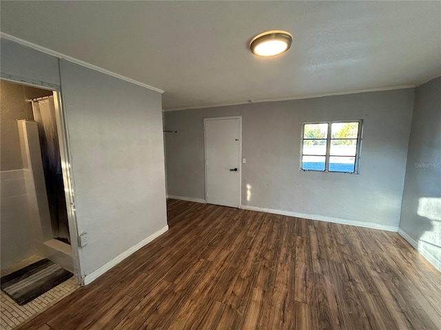 spare room with crown molding and dark hardwood / wood-style floors