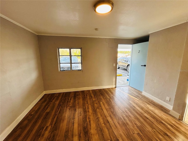 unfurnished room featuring wood-type flooring and crown molding