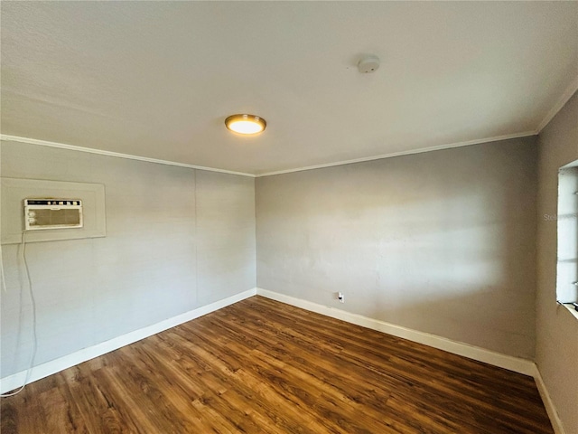 spare room featuring crown molding, dark wood-type flooring, and a wall mounted air conditioner