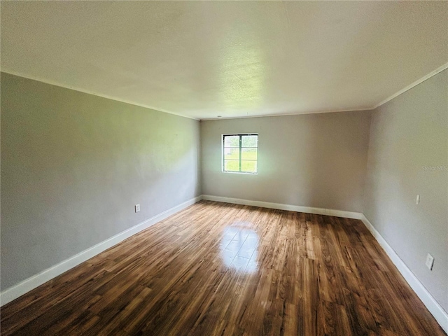 unfurnished room with wood-type flooring