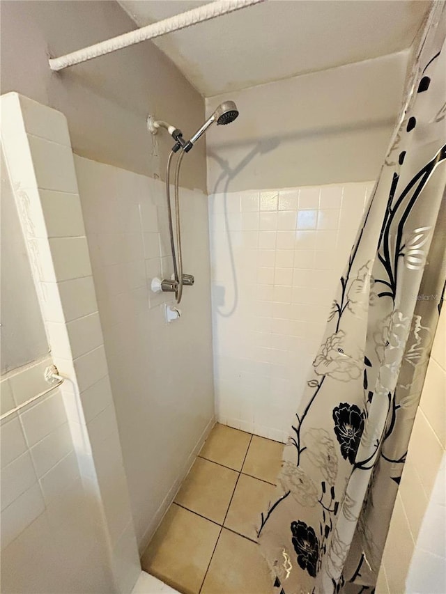 bathroom with tile patterned floors and a shower with shower curtain