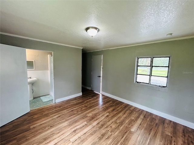 unfurnished bedroom with crown molding, hardwood / wood-style floors, and a textured ceiling