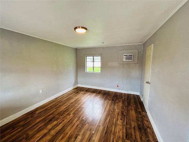 empty room featuring dark hardwood / wood-style flooring, crown molding, and a wall mounted AC