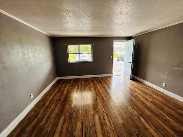 empty room with crown molding, dark wood-type flooring, and a textured ceiling