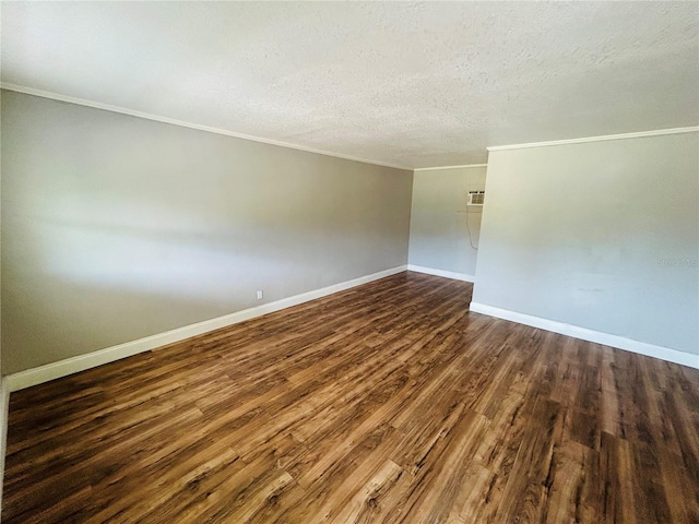 spare room with ornamental molding, dark hardwood / wood-style floors, and a textured ceiling