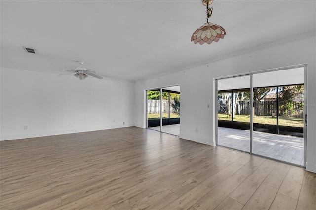 empty room with ceiling fan and light hardwood / wood-style floors