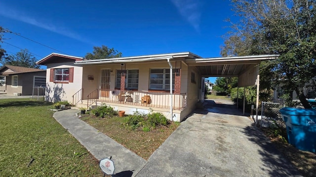 view of front of home with a carport, covered porch, and a front yard