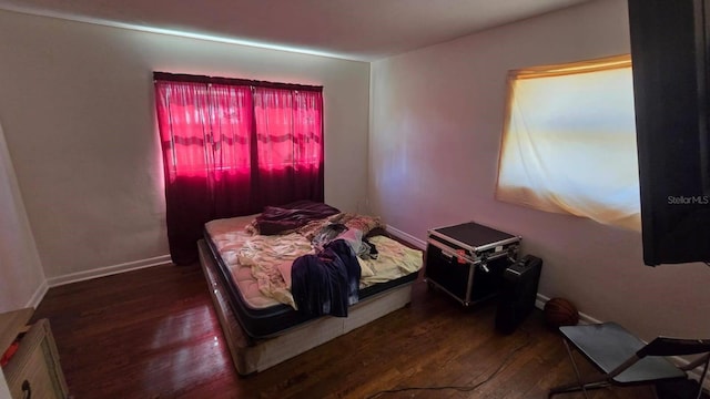 bedroom with dark wood-type flooring