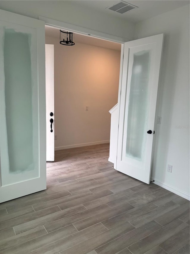 corridor with light hardwood / wood-style floors