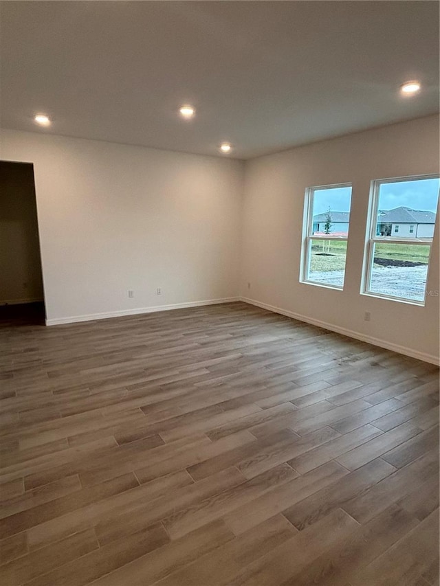 unfurnished room with hardwood / wood-style flooring