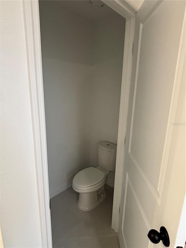 bathroom featuring tile patterned flooring and toilet