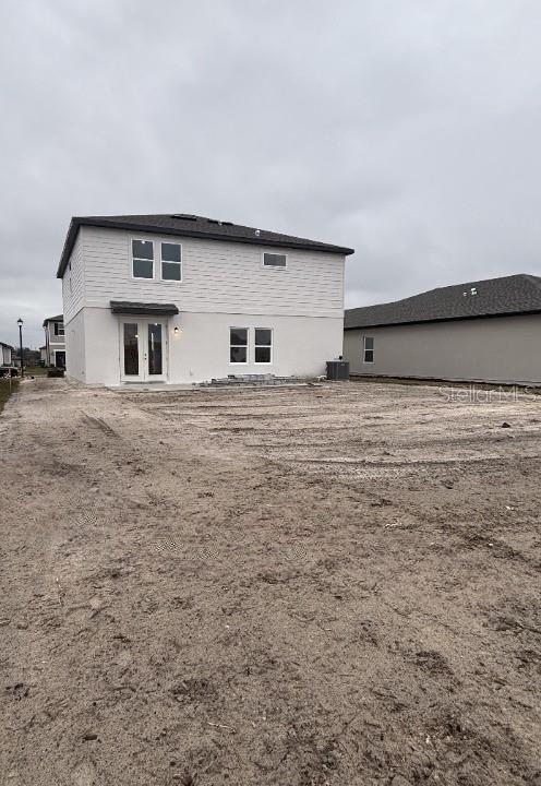 back of house featuring central AC unit