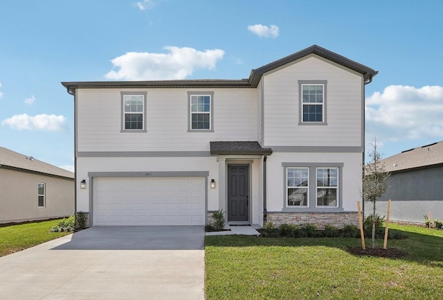 traditional-style home featuring an attached garage, concrete driveway, stone siding, stucco siding, and a front lawn