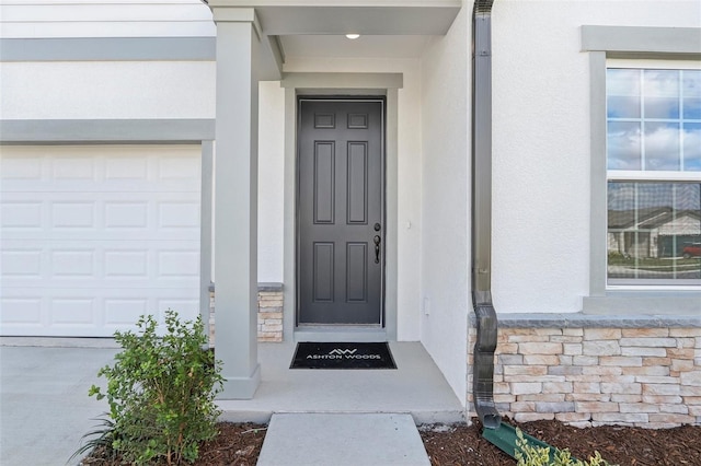 entrance to property with stone siding and stucco siding