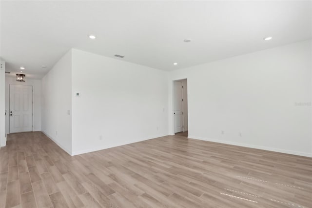 spare room with light wood-type flooring, visible vents, and recessed lighting