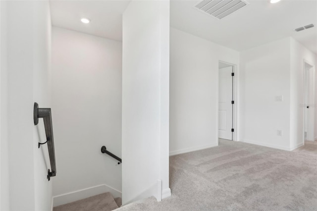 carpeted spare room featuring recessed lighting, visible vents, and baseboards