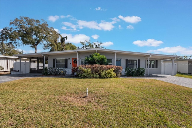 view of front of house with a carport and a front lawn